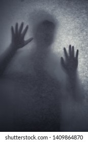 A person foreshadowing on a life-sized hand-made paper under the perfect lighting , creating a sense of mystery and horror. - Shutterstock ID 1409864870
