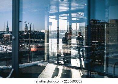 Person In Front Of Multiple Reflections In Central Stockholm