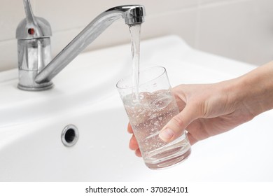 Person Gaining Cold Drinking Water From The Tap