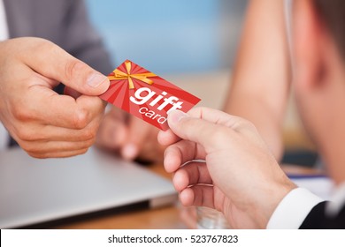 Person Giving Gift Card