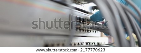 Person in glove connect cable network to internet switch server in data center.