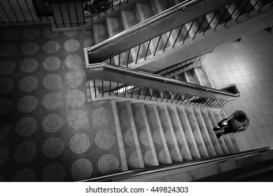 Person Going Up The Stairs .black And White Picture.Image Contain Grain , Noise And Soft Focus Due Long Exposure.