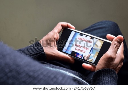 Person got potential deep fake content message during watching a footage on his mobile phone. Selective focus 商業照片 © 