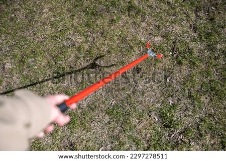 Similar – Image, Stock Photo Person with Grabber Reacher Tool