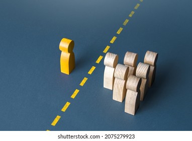 A person and a group of people are separated by a yellow line. Establishing contact. Distrust. Quarantine. Distance with strangers. Barrier to understanding, difficult integration. Rejection, refusal. - Shutterstock ID 2075279923