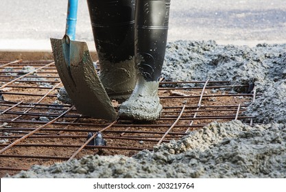 Person With Gum Boots Spreading Ready Mix Concrete