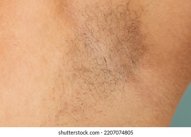 Person with hairy underarms closeup, free copy space, skin background. Arm with armpit hair. Female beauty trend, freedom, sensitive skin, growing body hair, feminism, body positive, naturalness. - Shutterstock ID 2207074805