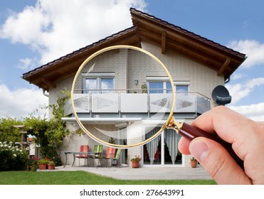 Person Hand With Magnifying Glass Over Luxury House - Shutterstock ID 276643991