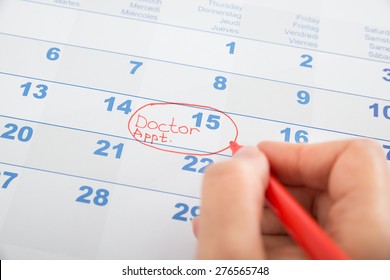 Person Hand Marked Doctor Appointment On Calendar
