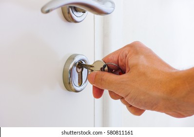 Person Hand Ready To Open Door By Key.