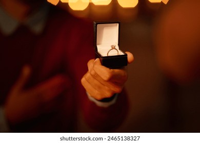 Person, hand and ring box for engagement proposal for marriage question at night, romantic or surprise. Jewellery, diamond and valentines day celebration or announcement ask, elegant or relationship - Powered by Shutterstock