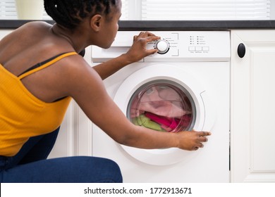 Person Hand Setting Washing Machine For Clothes Laundry