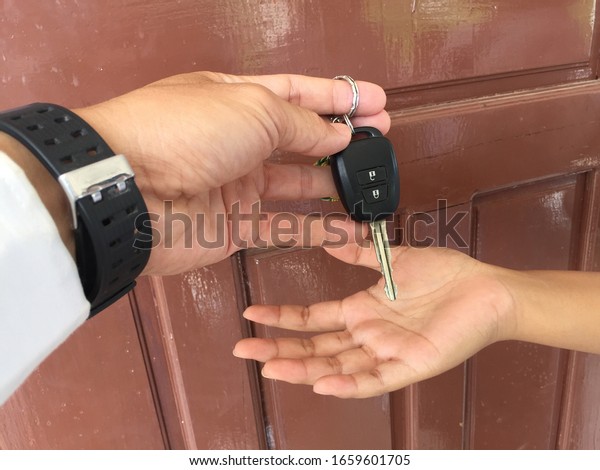 The person handed the car key to a loved one. When\
driving a car