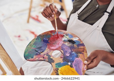 Person, hands and art with palette in closeup for painting on canvas for creative expression and hobby at home. Painter, artwork and color mixing tool with paintbrush in workshop for inspiration - Powered by Shutterstock