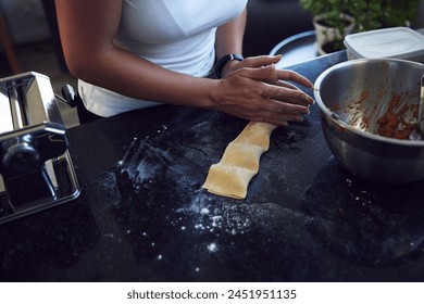 Person, hands and cooking pasta with mixing bowl on kitchen counter for healthy diet and nutrition at home . Woman, chef and food in closeup for handmade preparation of ravioli for balanced meal - Powered by Shutterstock