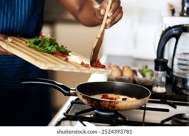 Person, hands and frying pan for meal in home, stove closeup and eggs for protein or nutrition. Breakfast, kitchen and organic ingredients for food preparation, healthy and cooking with vegetables