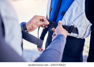 Person, hands and helping with life jacket for safety, security and people prepare for water, boat and journey on river with protection. Lake, lifejacket or adventure with man and woman in vest