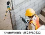 person hands hold hammer drill. Builder worker with pneumatic hammer drill perforator equipment making hole in wall at construction site