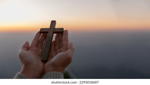 Person hands palm up praying and worship of cross with Belief in Jesus Christ. Eucharist therapy god blesses help, hope, and faith, Christian religion concept on sunset background. - Powered by Shutterstock