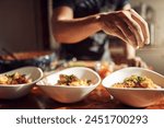 Person, hands and prepare food or meal, kitchen and culinary art for cooking in apartment. Healthy, nutrition or lunch serving on counter, gourmet and garnish for presentation on delicious chef dish