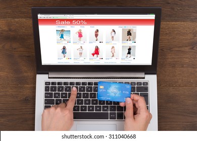 Person Hands Shopping Online With Credit Card And Laptop At Desk