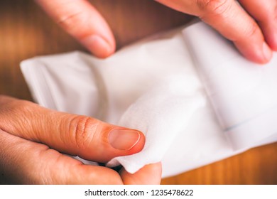 Person Hands Taking Wet Wipe From Package. 