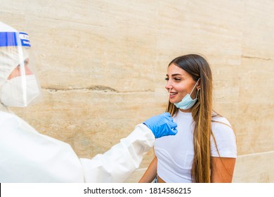 Person Health Care Worker Taking Coronavirus Swab - Wearing Personal Protective Equipment Performing A Coronavirus COVID-19 Test - Operations Coronavirus Mobile Testing Unit A Healthcare Worker