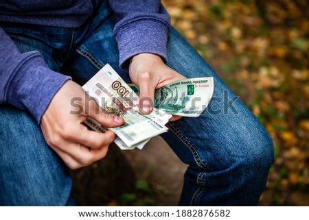Person hold and count a Russian Money on the Street closeup
