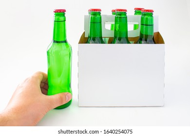 A Person Holding A Beer With A Six Pack Of A Green Beer Bottles Isolated On White Background