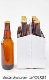 A Person Holding A Beer With A Six Pack Of A Brown Beer Bottles Isolated On White Background