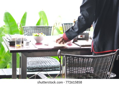 Person holding collecting in hands dirty dishes restaurant background, waitress working in restaurant, working concept. - Powered by Shutterstock