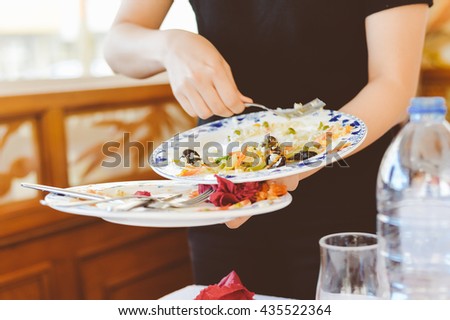 Person holding collecting in hands dirty dishes restaurant background ストックフォト © 
