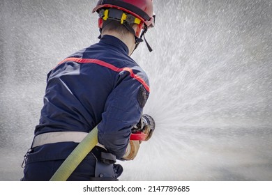 Person Holding A Fire Hose During A Drill