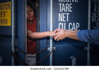 A person holding and helping to pull a several woman's hand which is inside a container, to human trafficking and illegal immigration concept. - Shutterstock ID 2131411789
