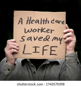 Person Holding A Homemade Sign In Both Hands After Receiving Lifesaving Help From A Healthcare Worker, Coronavirus, Covid-19, Nurses Doctors Front Line Essential Workers, Coronavirus Survivors Patient