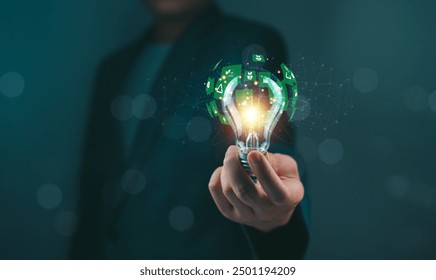 Person holding illuminated light bulb with green energy concept. Creative idea and innovation representation. - Powered by Shutterstock