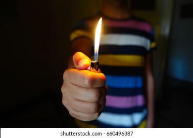 A Person Holding Up A Lighter