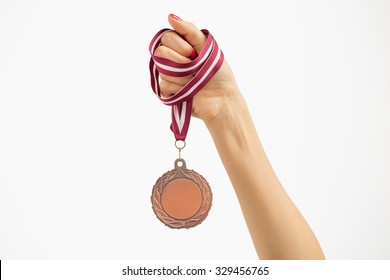 Person holding a medal  - Powered by Shutterstock