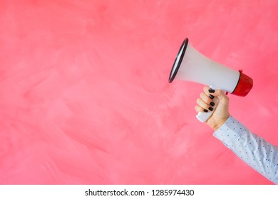 Person Holding Megaphone On Empty Pink Background