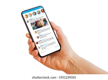 Person holding mobile phone in hand with sample social media microblogging app on the screen