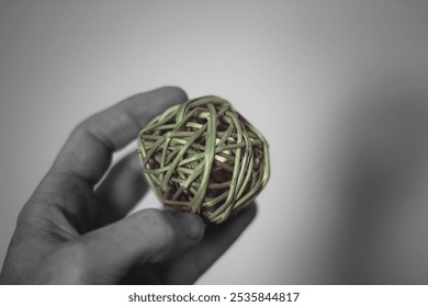 person holding up natural bamboo wicker vine ball texture decor simple minimalist isolated background - Powered by Shutterstock