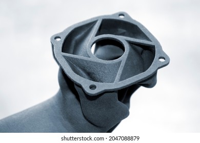 Person holding object printed on powder industrial 3D printer.