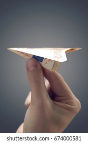 Person Holding Paper Airplane Made Of 50 Euro Note, Close-up Of Hand