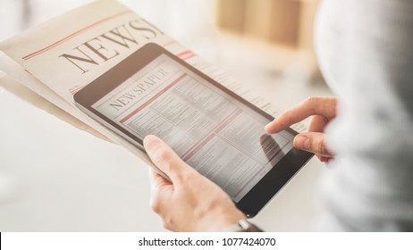 Person holding and reading news from tablet