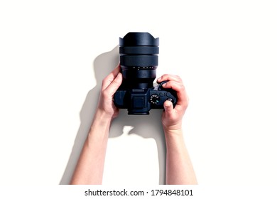 Person holding a SLR camera from above