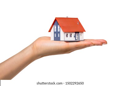 Person Holding A Small Model House In The Hand Isolated In Front Of White Background