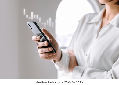 Person holding a smartphone, checking data. Smartphone in hand, data analysis. Casual attire, focused on smartphone. Modern technology, smartphone usage. Business and technology image.