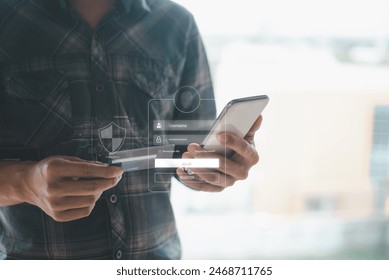 A person holding a smartphone and credit card, engaging in online banking or shopping with digital security icons overlay. - Powered by Shutterstock