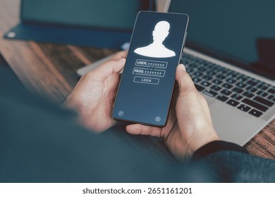 A person is holding a smartphone displaying a login screen on its display a generic user profile icon by input fields for "USER:" and "PASS:", asterisks and "LOGIN". Data protection concept.

