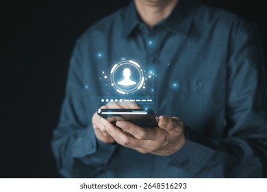 A person holding a smartphone displaying a user profile icon and to be a loading or authentication bar. Concept online security, digital identity, data protection.
